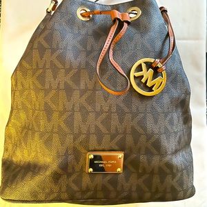 MK Monogram Jules drawstring shoulder bag, brown